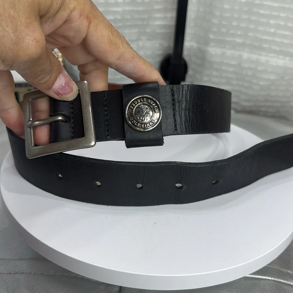 (H)Two Pebble Beach boys' leather belts with black and white metal silve buckles